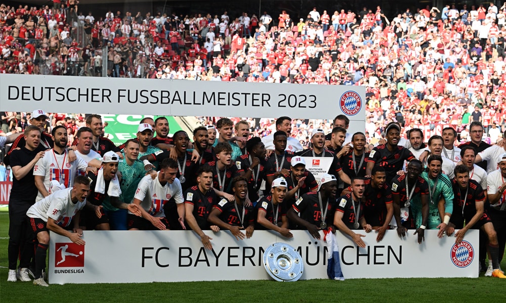 Bayern Munich's players celebrate with the trophy after the German first division Bundesliga football match between FC Cologne and FC Bayern Munich in Cologne, western Germany on May 27, 2023.