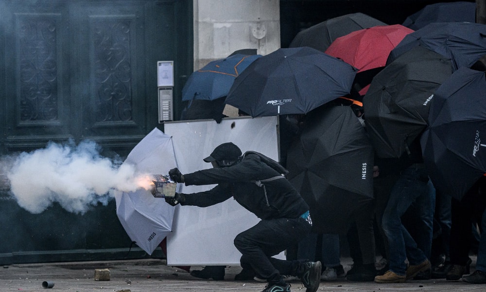 A protestor fires fireworks as they clash with riot police during a demonstration on May Day (Labour Day), to mark the international day of workers, more than a month after the government pushed an unpopular pensions reform act through parliament, in Nantes, northwestern France, on May 1, 2023.