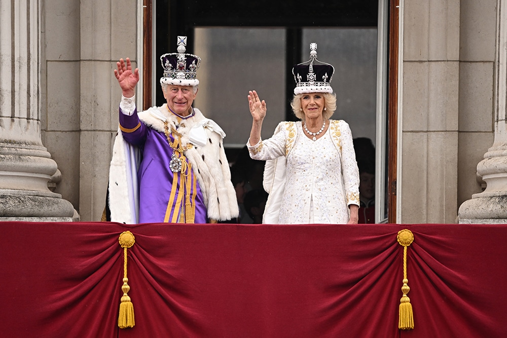 LONDON: Britain’s King Charles III, wearing the Imperial State Crown, and Queen Camilla, wearing a modified version of Queen Mary’s Crown, wave from the Buckingham Palace balcony after viewing the Royal Air Force fly-past on May 6, 2023 after their coronations. — AFP