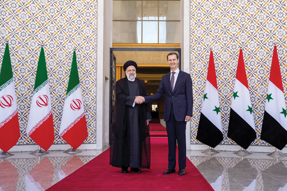 DAMASCUS: Syrian President Bashar Al-Assad receives his Iranian counterpart Ebrahim Raisi at the presidential palace on May 3, 2023. — AFP