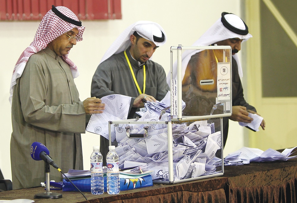 KUWAIT: A judge and his aides count the ballots at a polling station after closure of voting in Sabah Al-Salem in this Feb 2, 2012 file photo. – AFP