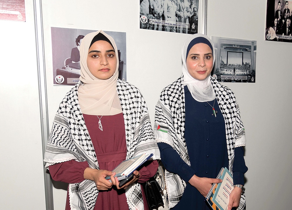 Palestinian women browse the art gallery on the sidelines of the event.