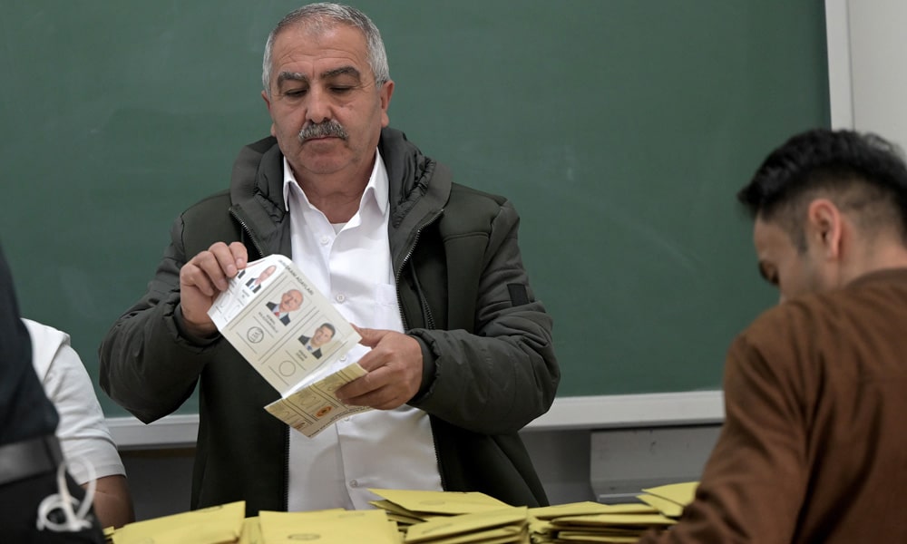 Election officials count ballots at a polling station in Istanbul on May 14, 2023, after polls closed in Turkey's presidental and parliamentary elections.