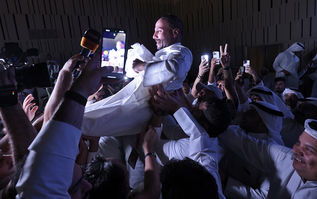 KUWAIT: Kuwaiti candidate and former parliament speaker Marzouq al-Ghanim celebrates with his supporters following the announcement of his victory in legislative elections, in Kuwait city, on early June 7, 2023. -- Photos by Yasser Al-Zayyat