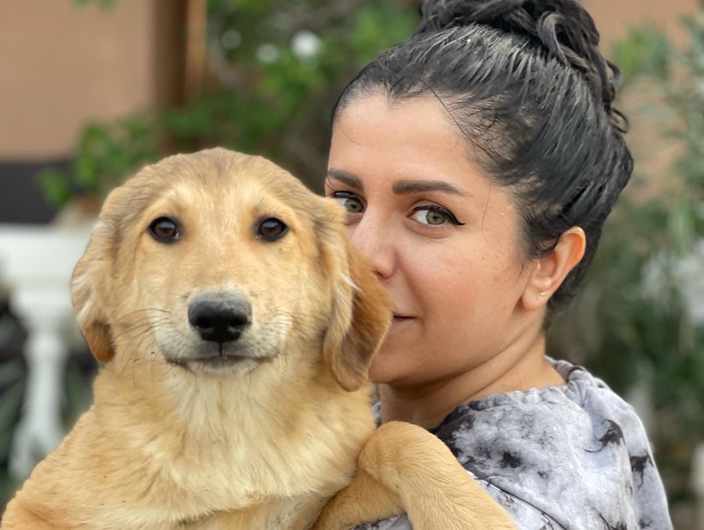 Elika Mansouri poses with a dog.
