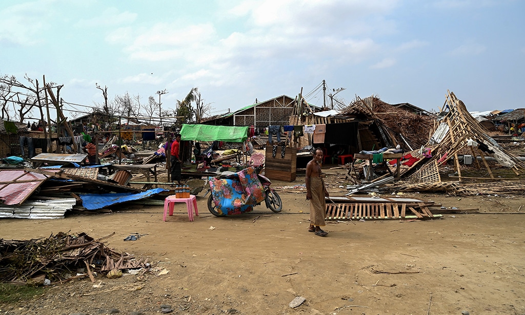 SITTWE: A man walks past the destroyed houses at That Kel Pyin refugee camp in Sittwe in the aftermath of Cyclone Mocha’s landfall. – AFP
