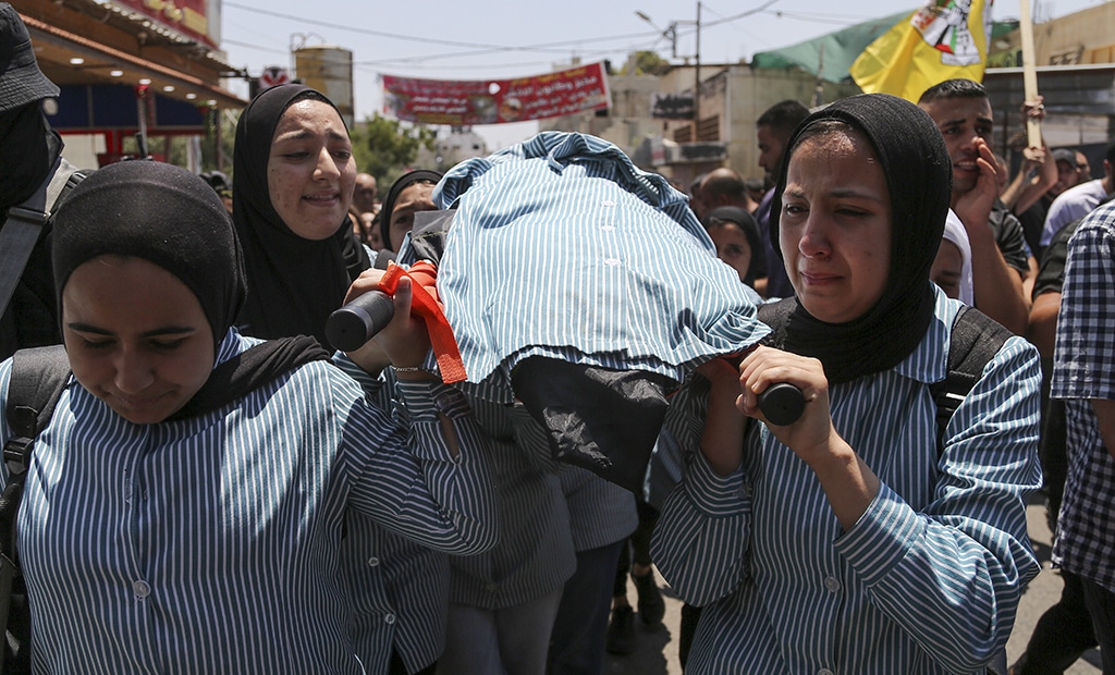 JENIN: Palestinian schoolgirls mourn during the funeral of their classmate, 15-year-old Sadil Naghnaghiya, in the occupied West Bank on June 21, 2023. – AFP