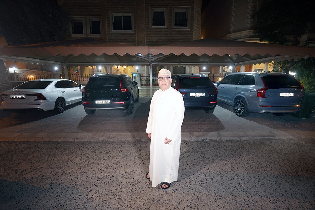 Fadhel Al-Baghli poses for a photo with this cars.