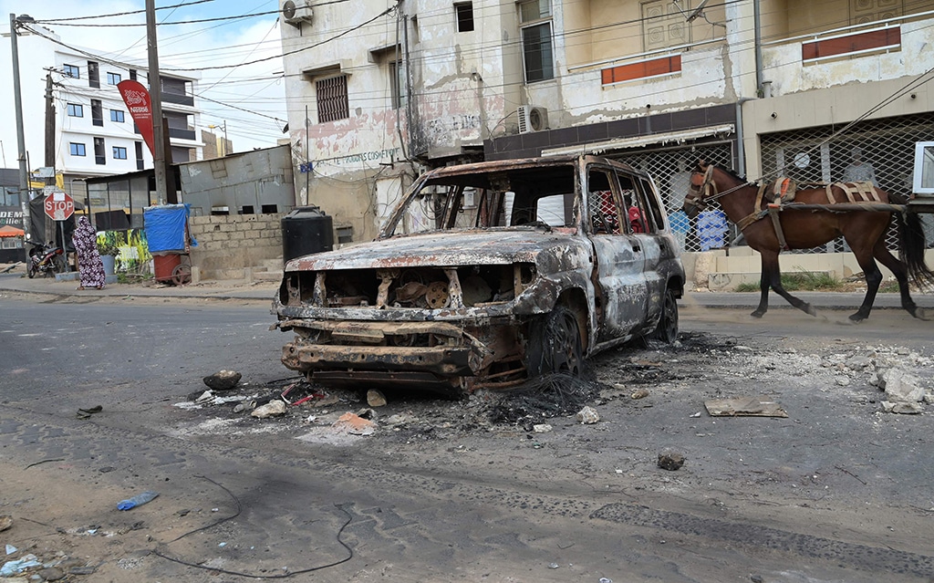 DAKAR: This general view shows the charred remains of a vehicle on a street on June 3, 2023, following deadly violence in the Senegalese capital. – AFP