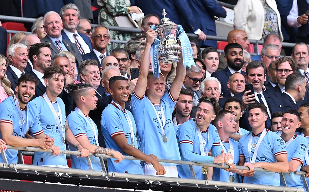 LONDON: Manchester City’s Norwegian striker Erling Haaland (center) lifts the trophy after the English FA Cup final football match between Manchester City and Manchester United at Wembley stadium on June 3, 2023. – AFP
