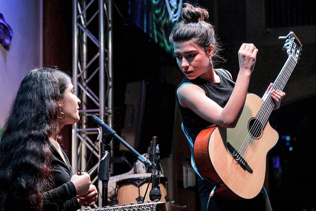 Syrian-Kurdish refugees and musicians Norshean Salih (right), 23, and her sister Perwin Salih, 20, perform in Arbil, the capital of the autonomous Kurdish region of northern Iraq.