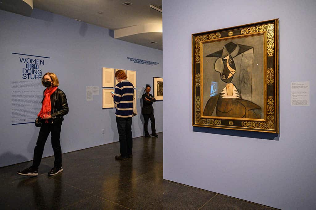 People walk past a work of art by Pablo Picasso titled 'Woman in Grey' on display at an exhibition titled 'It's Pablo-matic: Picasso According to Hannah Gadsby' at the Brooklyn Museum in the Brooklyn borough of New York City.--AFP