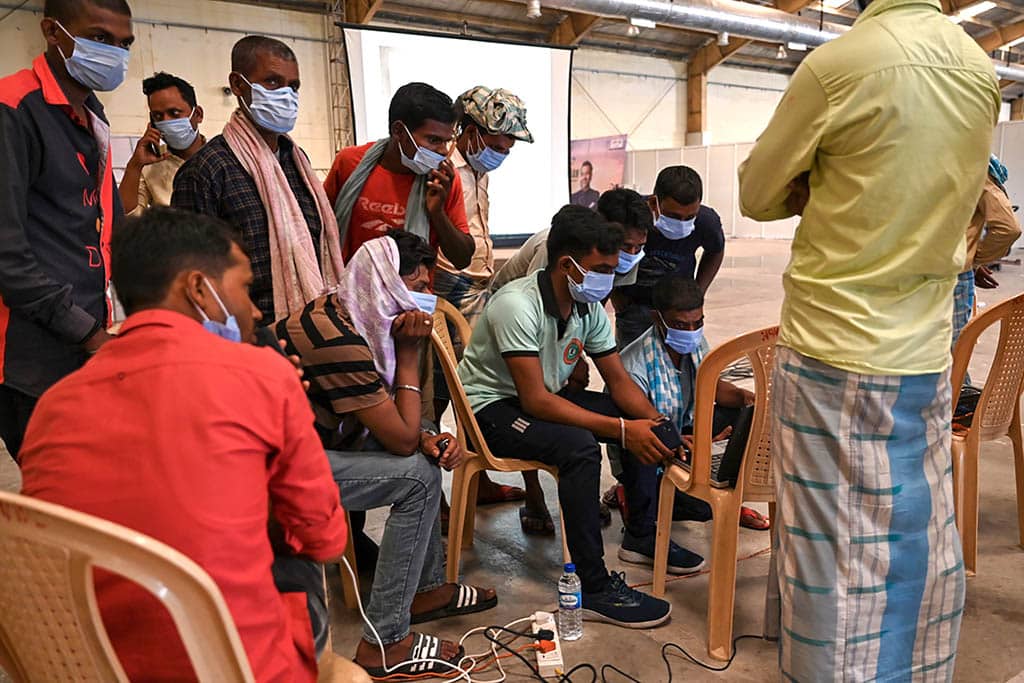 BALASORE: Victims' family members look at photographs to identify bodies at a business park used as temporary mortuary for the dead recovered from the carriage wreckage of a three-train collision near Balasore, in India's eastern state of Odisha. – AFP