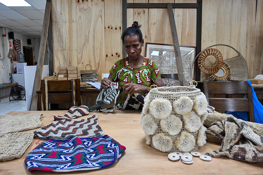A woman making a traditional Papua New Guinean 'Bilum' bag at a workshop in Port Moresby.