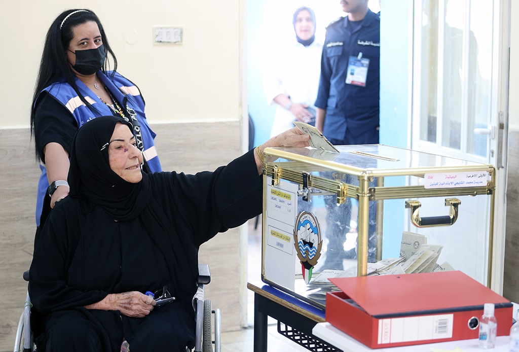 A Kuwaiti woman casts her vote during parliamentary elections in Kuwait City on June 6, 2023. - photos by Yasser Al-Zayyat