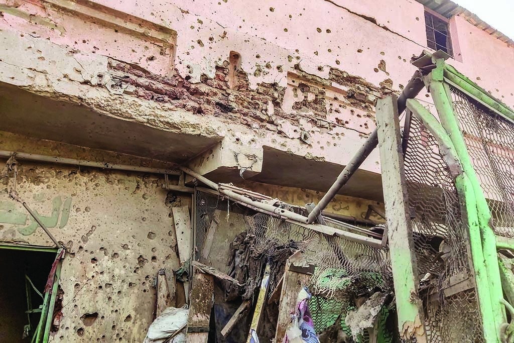 KHARTOUM: Bullet holes riddle the wall of a building at the Souk Sitta (Market Six) in the south of Khartoum on June 1, 2023. - AFP