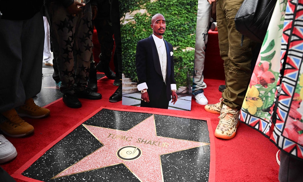 A portrait of US rapper Tupac Shakur is displayed next to his newly unveiled star during his Hollywood Walk of Fame star ceremony in Hollywood, California, on June 7, 2023.