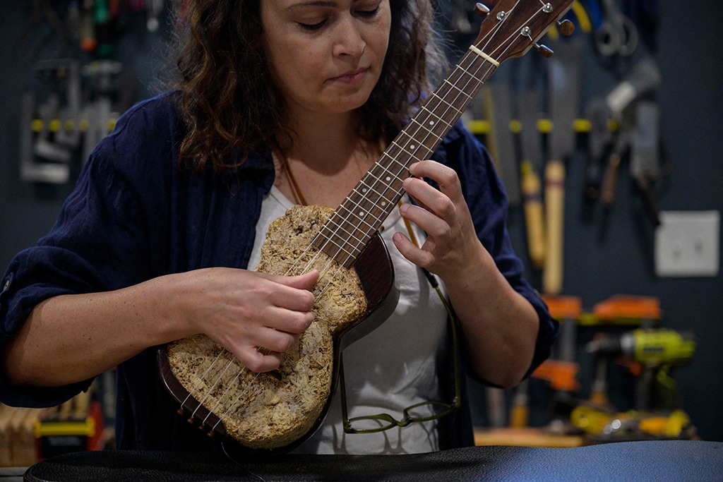 French luthier Rachel Rosenkrantz plays a ukulele made using mycelium in her studio in Providence, Rhode Island.