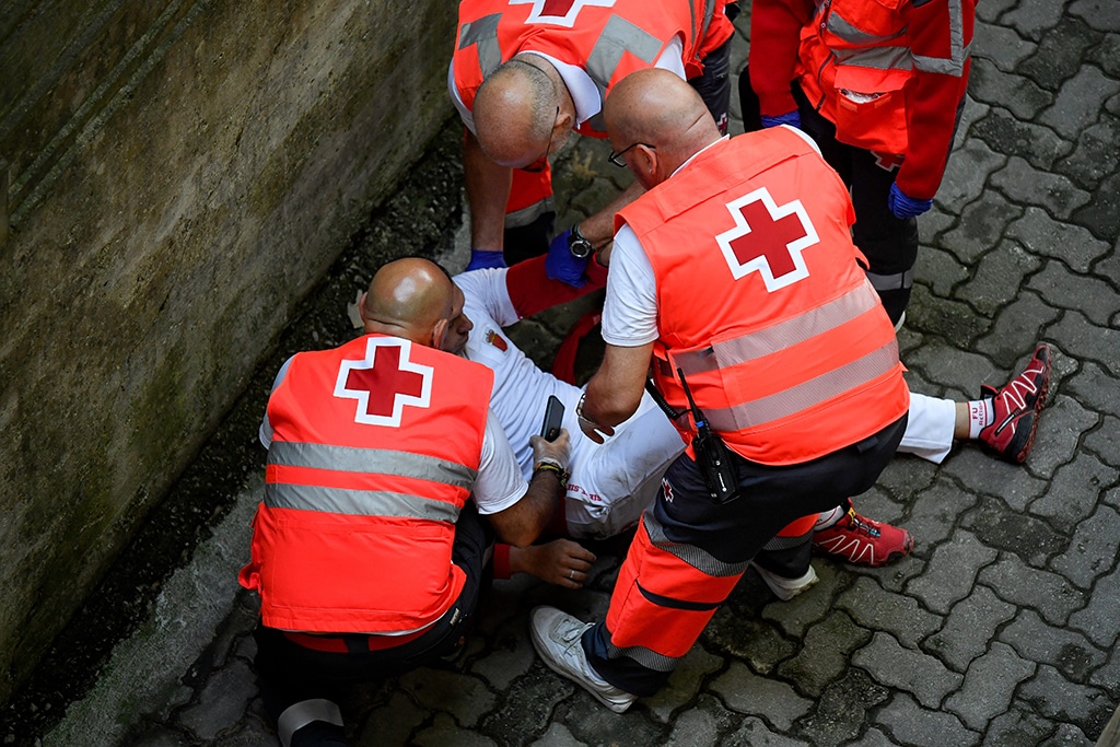 First-responders of the Red Cross tends to an injured participant after the 'encierro' (bull-run) of the San Fermin festival in Pamplona.