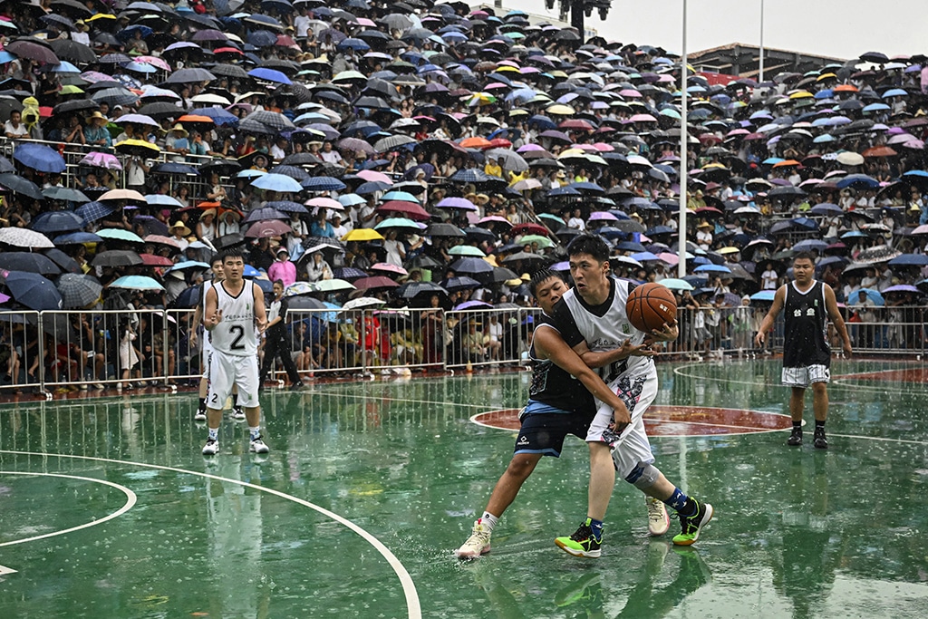 This photo  shows players competing during an invitational game of the grassroots basketball competition CunBA in Taipan village, Taijiang county, in southwestern China's Guizhou province.