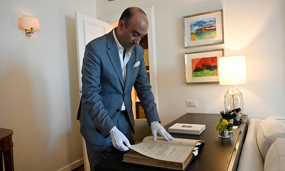 Copacabana Palace General Manager Ulisses Marreiros handles the Golden Book.