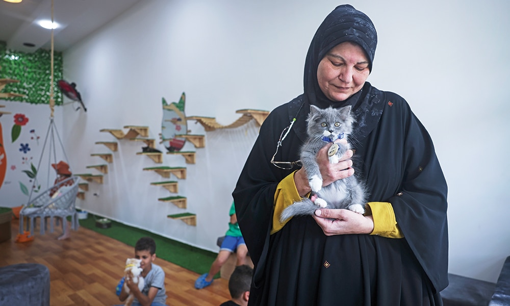 A woman holds a feline at the newly inaugurated Cat Cafe in Gaza City.