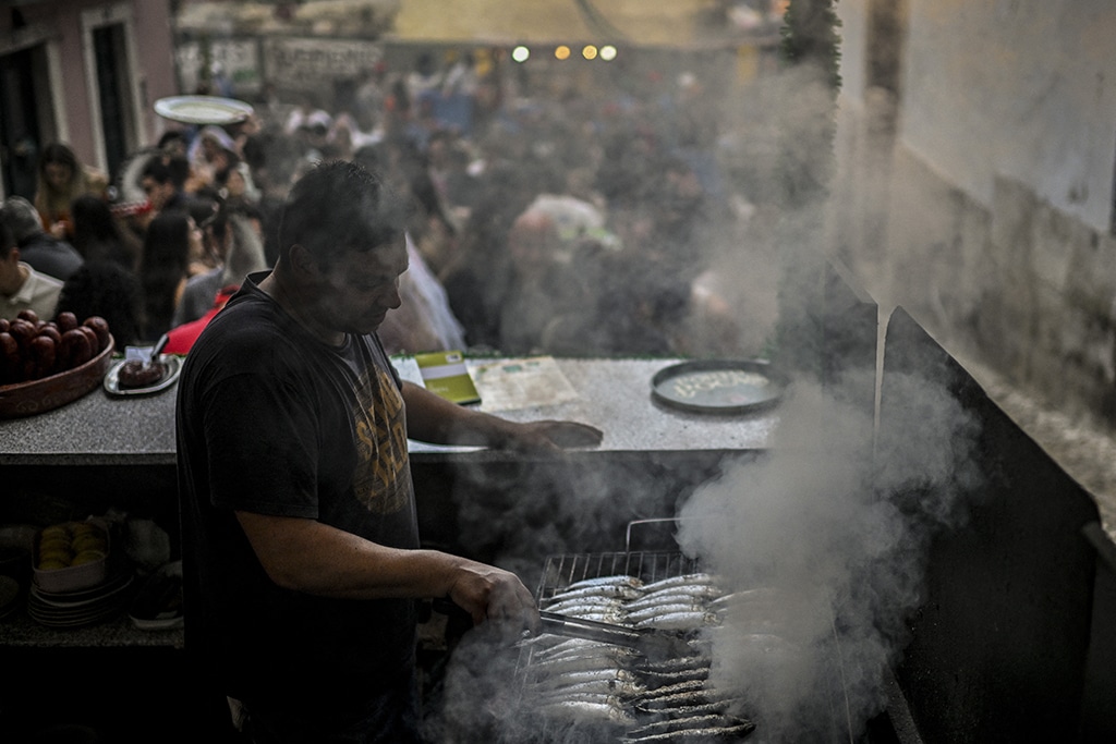 A man grills sardines during the Saint Anthony celebration.