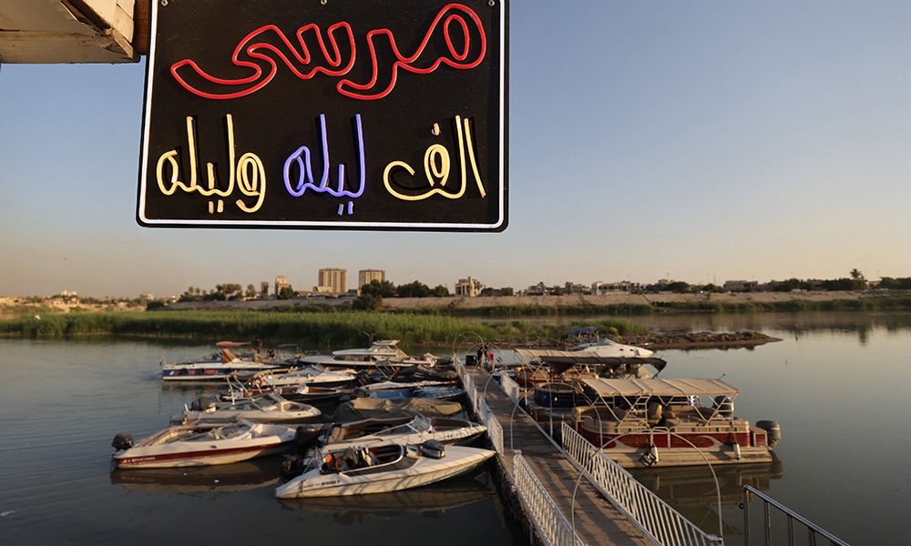 Boats are moored by a pier belonging to the 'One thousand And One Nights' entertainment resort.