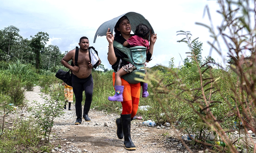 Migrants walk by the jungle near Bajo Chiquito village on September 21, 2023.