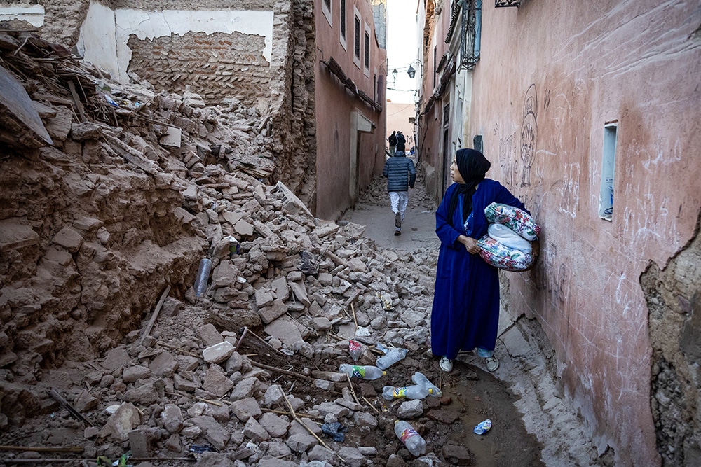 A woman looks at the rubble of a building in the earthquake-damaged old city in Marrakesh on September 9, 2023. —AFP