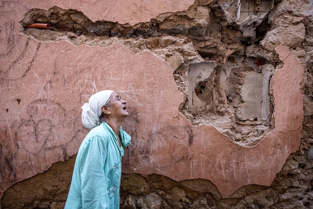 A woman reacts standing infront of her earthquake-damaged house in the old city in Marrakesh on September 9, 2023. - — AFP