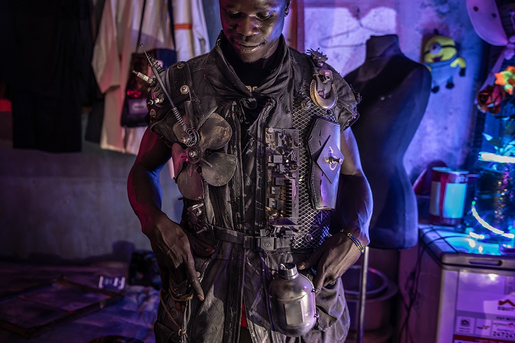 Fashion designer Pius Ochieng fits in one of his dystopian inspired designs at his house and creative studio in the informal settlement of Kibera in Nairobi ahead of the Kibera Fashion Week. --AFP photos