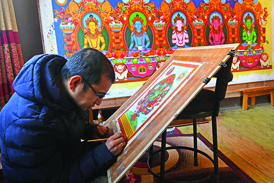 Paubha artist Ujay Bajracharya works on his rendition of the Green Tara, a goddess of compassion revered by Buddhists and Hindus in the country, in Lalitpur on the outskirts of Kathmandu.—AFP p hotos