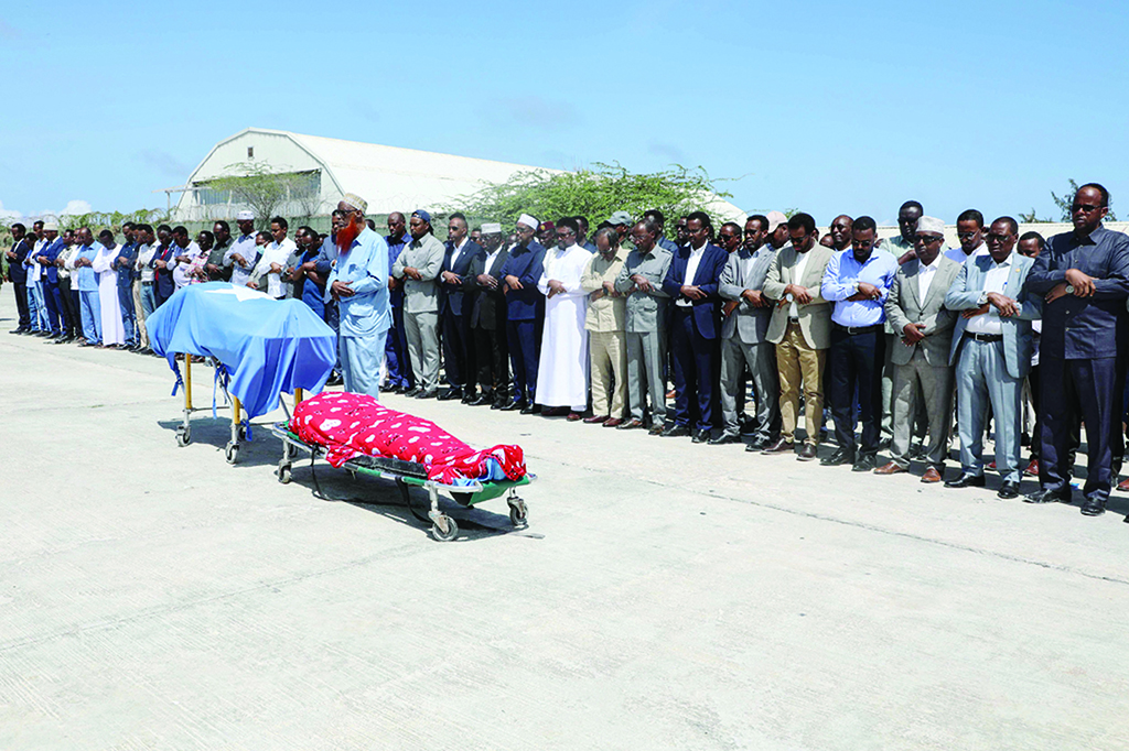 Mogadishu: Political leaders pray in front the two bodies of the local lawmakers including Amina Mohamed Abdi after being airlifted from Beledweyne, at Aden Adde International Airport in Somalia.- AFP
