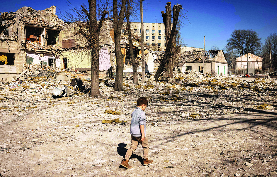 ZHYTOMYR: A children walks in front of a damaged school in the city of Zhytomyr, northern Ukraine.—AFP