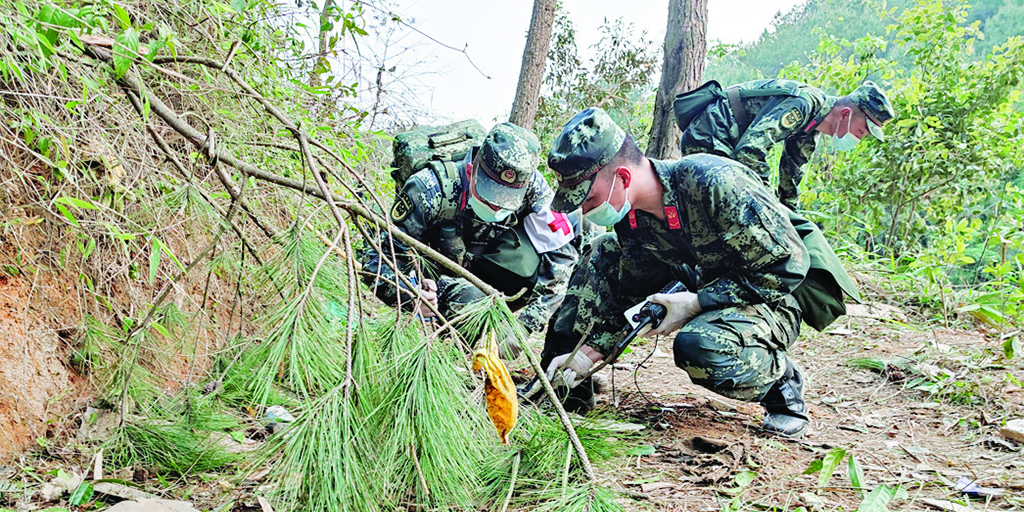 WUZHOU, China: Paramilitary police officers conducting a search at the site of the China Eastern Airlines plane crash in Tengxian county, Wuzhou city, in China's southern Guangxi region. A China Eastern passenger jet carrying 132 people crashed onto a mountainside in southern China on March 21. - AFP