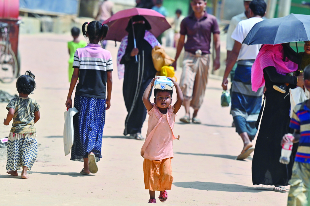 UKHIA, Bangladesh: In this picture taken on March 22, 2022, a Rohingya refugee child walks to her home at Jamtoli refugee camp in Ukhia. Hundreds of thousands of Rohingya fled Buddhist-majority Myanmar following the 2017 crackdown, which is now the subject of a genocide case at the United Nations' highest court in The Hague. - AFP