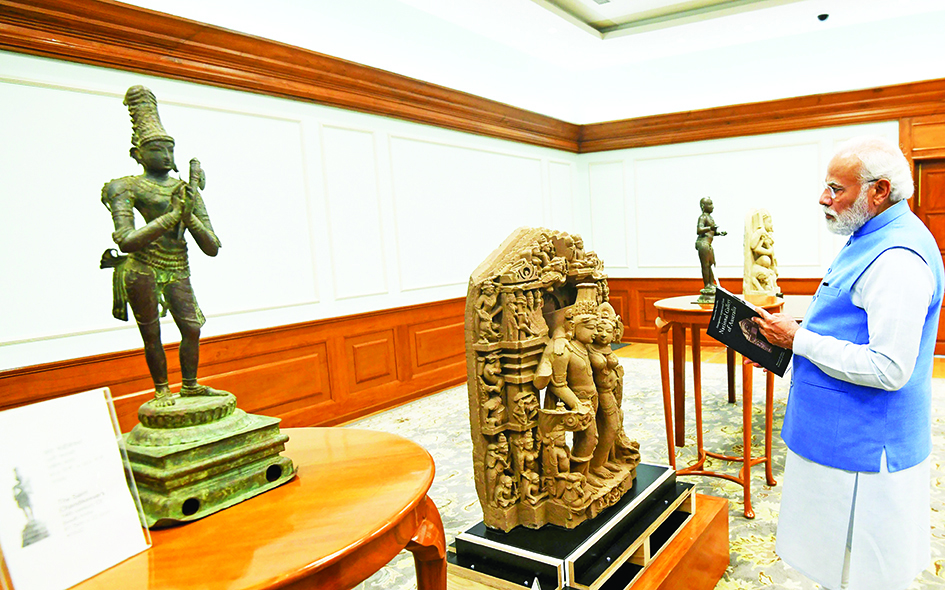NEW DELHI: This handout photograph taken yesterday and released by the Indian Press Information Bureau (PIB) shows India's Prime Minister Narendra Modi inspecting the antiquities repatriated from Australia, in New Delhi. – AFPn