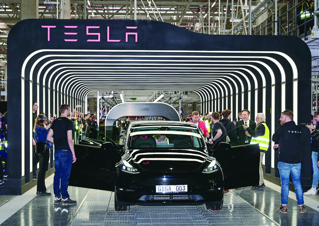 GRUNHEIDE, Germany: Tesla CEO Elon Musk (third right) rolls out an electric vehicle of the model Y as he attends the start of the production at Tesla’s “Gigafactory” on March 22.-AFP