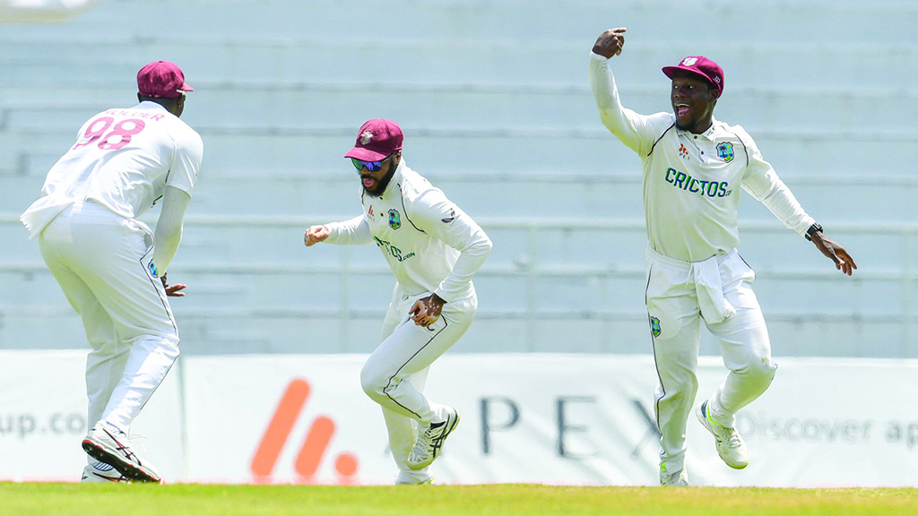 ST GEORGE'S: John Campbell (center) and Nkrumah Bonner (right) of West Indies celebrate the dismissal of Joe Root of England during the 3rd day of the 3rd and final Test between West Indies and England at Grenada National Cricket Stadium on March 26, 2022. - AFP