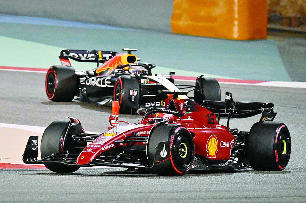 SAKHIR: Ferrari's Monegasque driver Charles Leclerc (foreground) and Red Bull's Dutch driver Max Verstappen (background) compete during the Bahrain Formula One Grand Prix at the Bahrain International Circuit in the city of Sakhir. - AFP