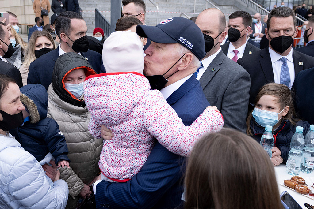 WARSAW: US President Joe Biden kisses a child while meeting refugees of Russia's war with Ukraine at PGE Narodowy Stadium on March 26, 2022. – AFP