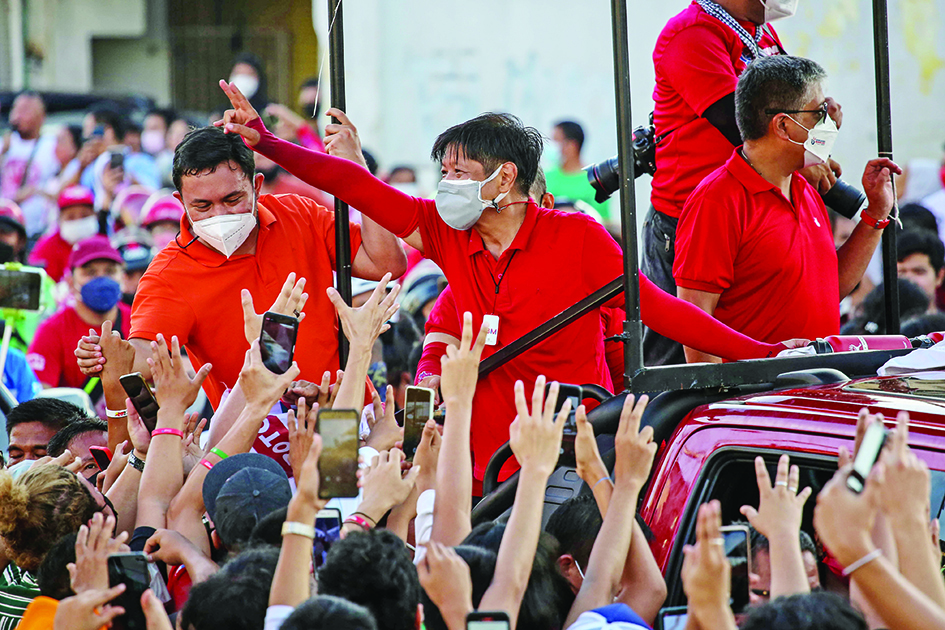 MANILA, Philippines:  In this photo taken on March 13, 2022, presidential candidate Bongbong Marcos, son of the late dictator Ferdinand Marcos, greets supporters during a campaign rally in Las Pinas City, suburban Manila. – AFP